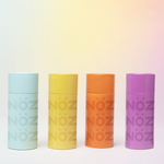 Load image into Gallery viewer, Nöz reef safe SPF sunscreen in teal, green, orange and pink.
