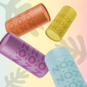 Nöz reef safe SPF sunscreen in teal, green, orange and pink.